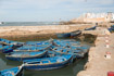 Blue painted boats belonging to fisherman lie inside the old harbour of Essaouira, Morocco