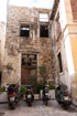 Mopeds parked in a tiny space in front of a semi-derelict building on a backstreet in Rethymnon, Crete