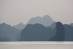 Islands emerge from grey evening mist in Halong Bay, Vietnam